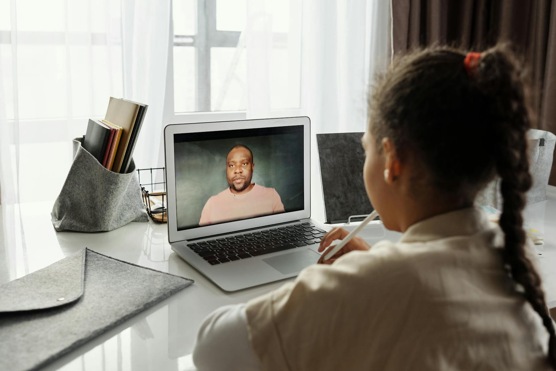 Child attending an online lesson at home via laptop. Remote education. on The Course Compass