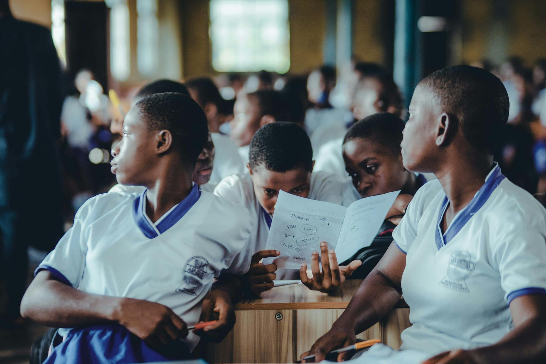 African students in a classroom collaborate on a learning assignment. on The Course Compass