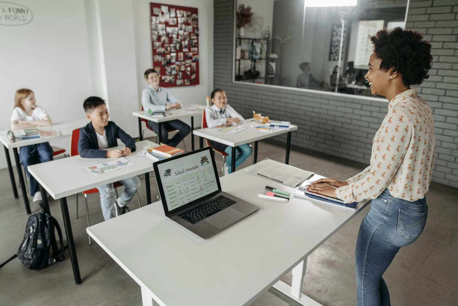 Teacher interacting with students in a modern classroom setting, fostering education. on The Course Compass