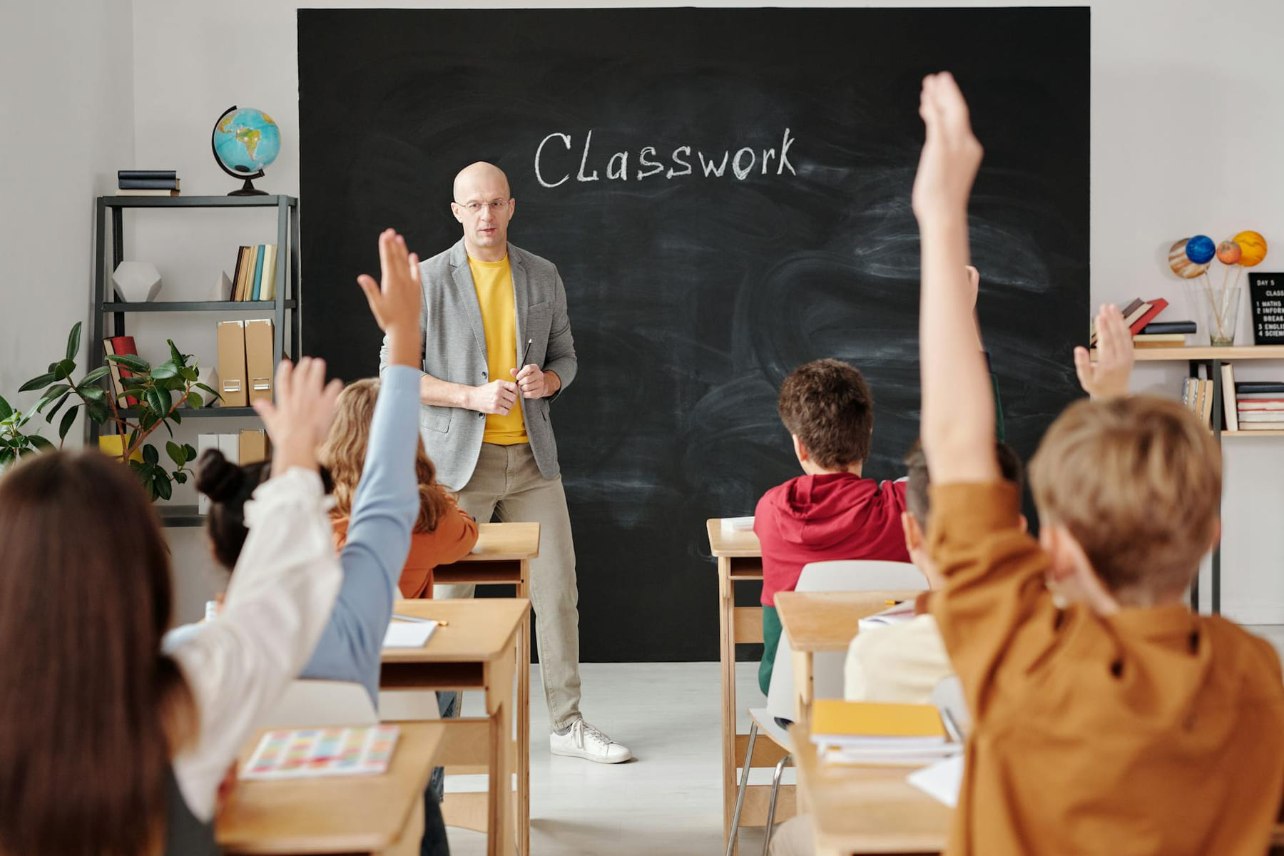 A teacher interacts with diverse students in a classroom, engaging them in active learning. on The Course Compass