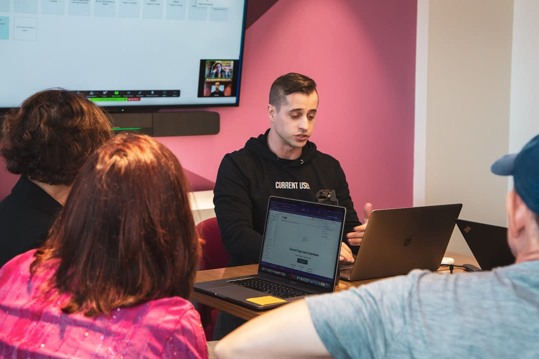 a person standing in front of a group of people using laptops on The Course Compass